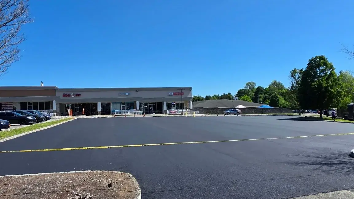 Freshly paved commercial parking lot at a New Jersey retail center