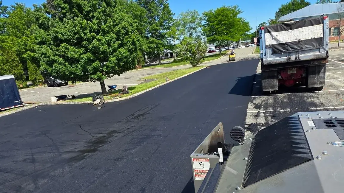 Paver laying a fresh asphalt mat on a New Jersey street