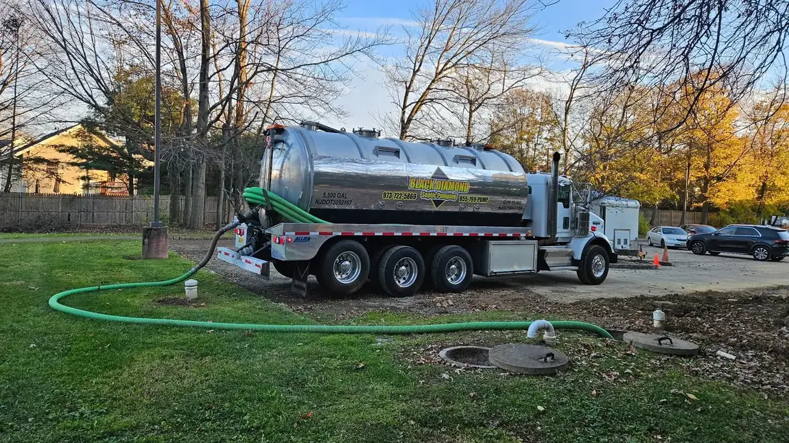 Black Diamond vacuum truck servicing a residential septic tank